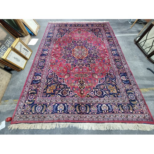 744 - Star lot : A beautiful very large hand knotted woolen Persian rug in shades of cerise and blue with ... 