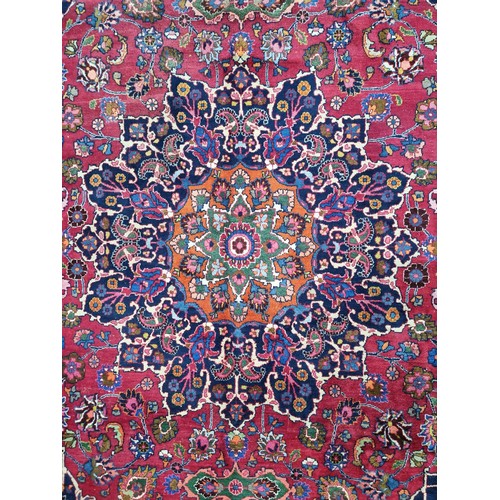 744 - Star lot : A beautiful very large hand knotted woolen Persian rug in shades of cerise and blue with ... 