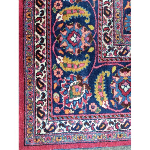 744 - Star lot : A beautiful very large hand knotted woolen Persian rug in shades of cerise and blue with ... 