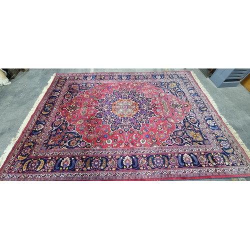 744 - Star lot : A beautiful very large hand knotted woolen Persian rug in shades of cerise and blue with ... 