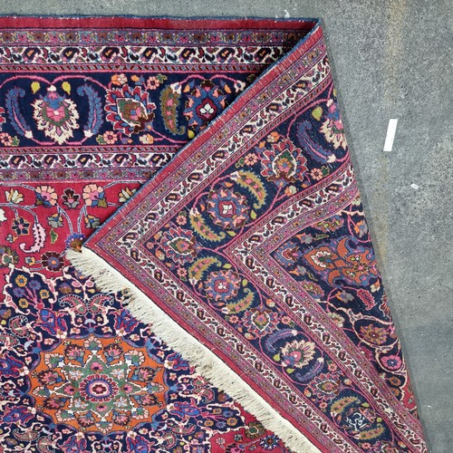 744 - Star lot : A beautiful very large hand knotted woolen Persian rug in shades of cerise and blue with ... 