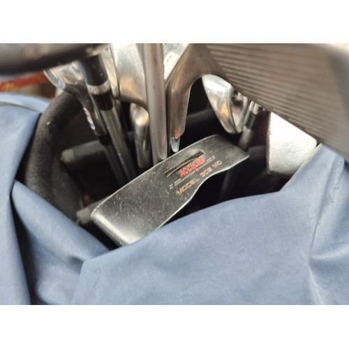 946 - A Maxfli golf  bag holding a large variety of golf clubs by Wilson including three high launch drive... 