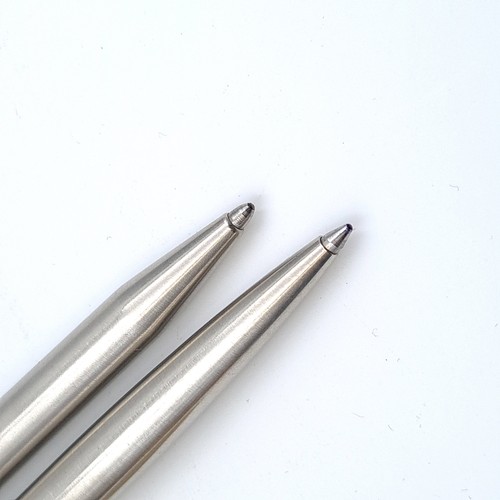 5 - Two vintage brushed chrome Parker ball point pens, featuring clean barrels.
