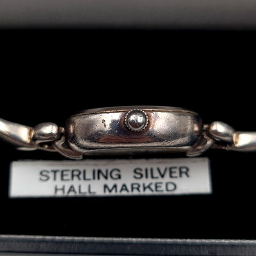 28 - A fine example of a sterling silver cased ladies wrist watch, featuring an associated silver bracele... 