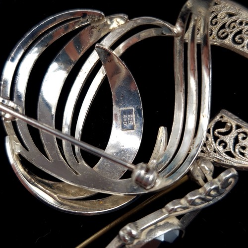 35 - A collection of three sterling silver brooches, in beautiful design and featuring an example set wit... 