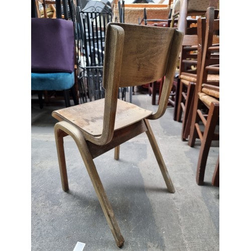 679 - A fantastic set of 13 vintage British made beech stacking chairs from Lamstak designed by James Leon... 