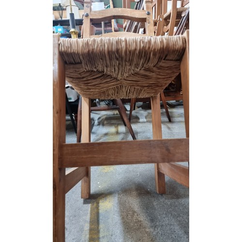 723 - A set of eight good quality ladderback dining chairs with woven sugan seats and large stud detailing... 