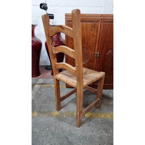 723 - A set of eight good quality ladderback dining chairs with woven sugan seats and large stud detailing... 