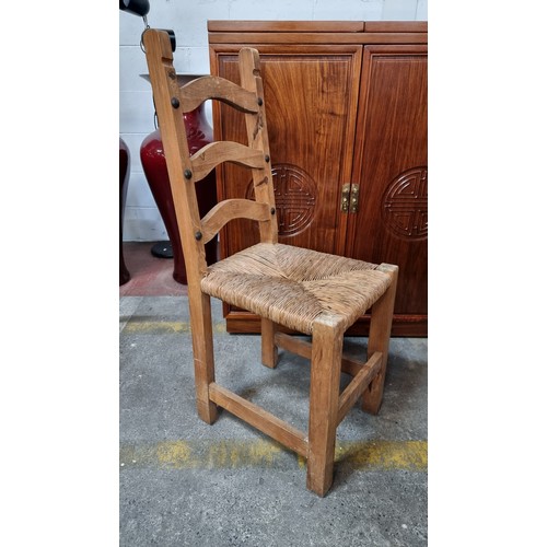 723 - A set of eight good quality ladderback dining chairs with woven sugan seats and large stud detailing... 