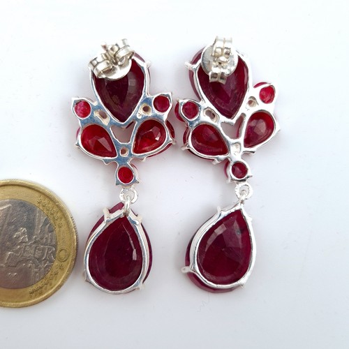 605 - Star Lot : A fine and generous pair of  natural Ruby tear drop earrings. Beautifully hued natural Ru... 