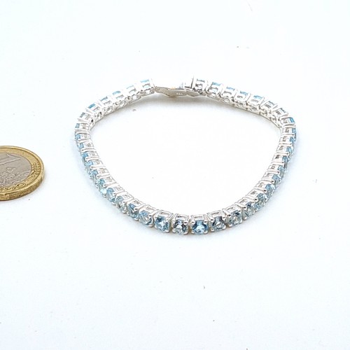 609 - Star Lot : A stunning natural Blue Topaz  tennis bracelet, set in Sterling Silver. Beautiful item on... 