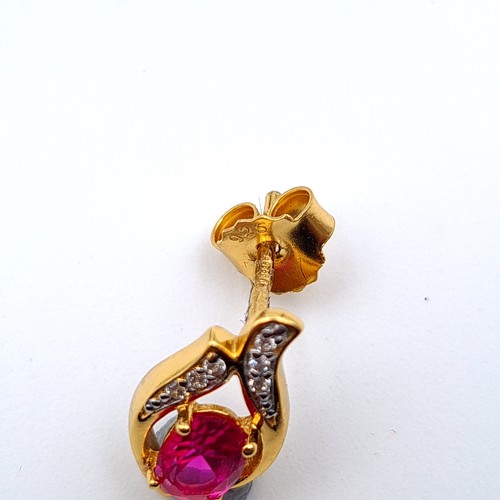 653 - A pair of natural Ruby and Sapphire 9 carat gold plated stud earrings. Old, new boxed stock.