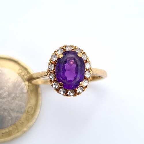 652 - Star Lot : A fine example of a 9 carat gold ring, which features an Amethyst central stone and surro... 