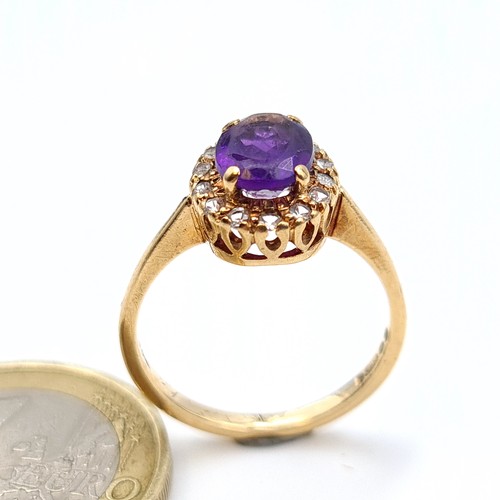 652 - Star Lot : A fine example of a 9 carat gold ring, which features an Amethyst central stone and surro... 