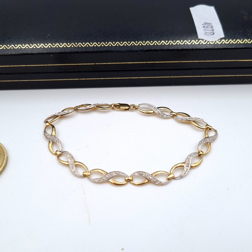 618 - A beautiful 9 carat gold bi-colour twist bracelet, set with attractive gem stone detail. Stamped 375... 