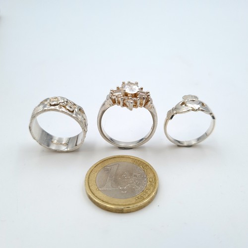 619 - A collection of three sterling silver rings, consisting of a Claddagh style ring. Ring size: L. Toge... 