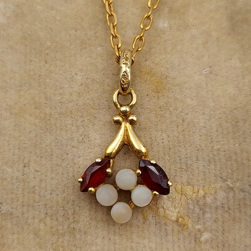 642 - Star Lot : A beautifully intricate antique art nouveau  9 carat gold Garnet and Opal drop pendant an... 