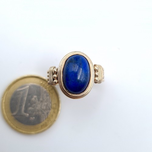 637 - A very attractive sterling silver Lapis Lazuli stone ring, set with a roped four strand channel cut ... 