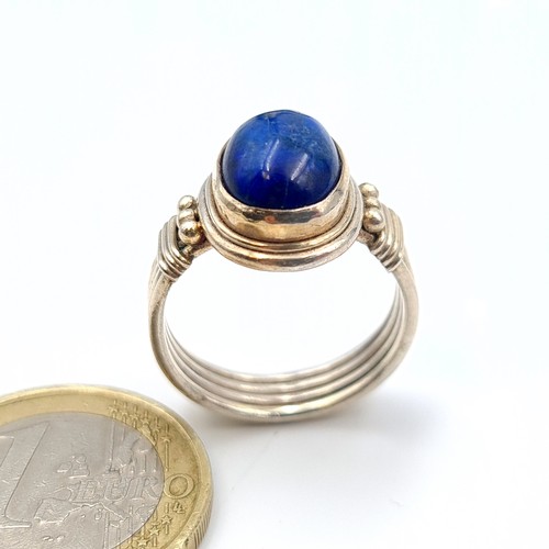 637 - A very attractive sterling silver Lapis Lazuli stone ring, set with a roped four strand channel cut ... 