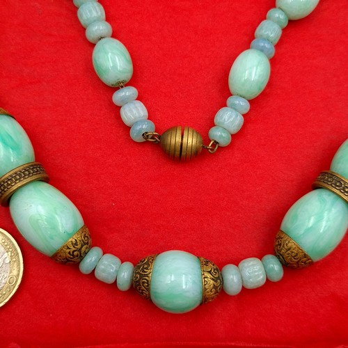 635 - A beautiful example of a graduated vintage natural Jade necklace, set with large beaded accents and ... 