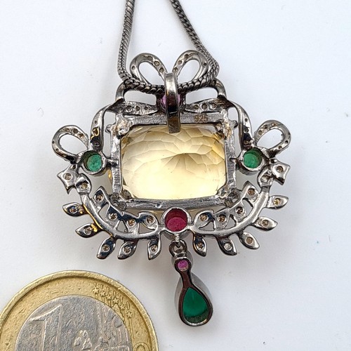 626 - A Citrine sterling silver gem stone pedant, set with Ruby, Emerald and Diamond accents. Comes with G... 