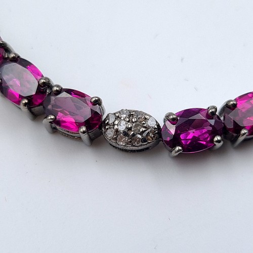 625 - Star Lot : A fine example of a Rhodolite and Diamond sterling silver tennis bracelet, of 11.9 grams.... 