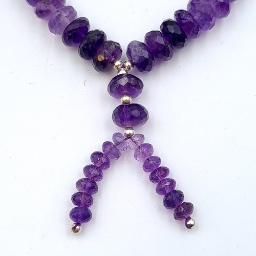 624 - A stunning Amythyst stone single strand graduated necklace, with a pretty tassel accent. This exampl... 