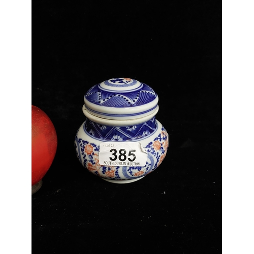 385 - A small antique porcelain Chinese lidded ginger jar with red dragon motif set on blue and white desi... 