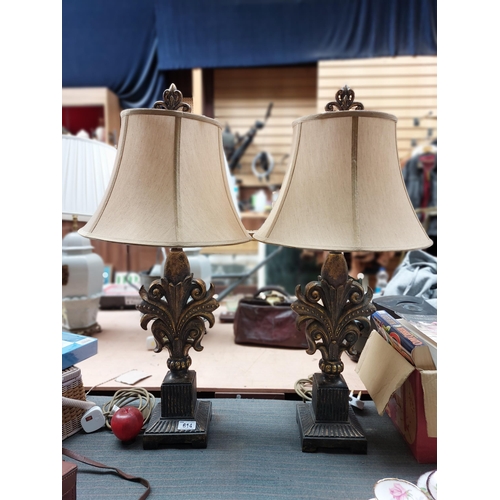 A beautiful pair of Baroque table lamps with sculptural bases with distressed gilt finish. Topped with soft gold shades and an ornate finial. H80cm
