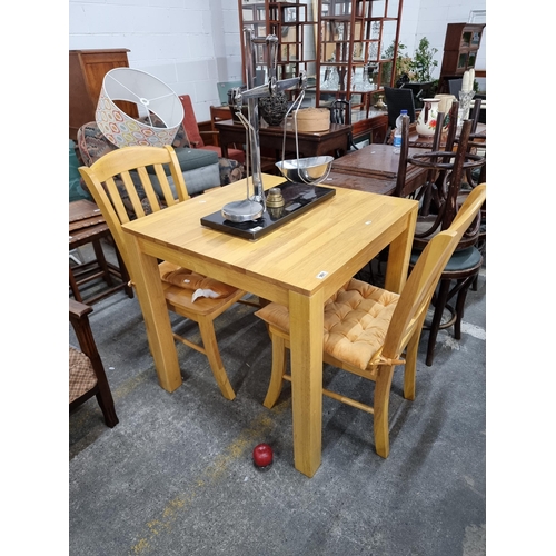 901 - A neatly proportioned solid pine dining table and two matching chairs. A conveniently sized seating ... 