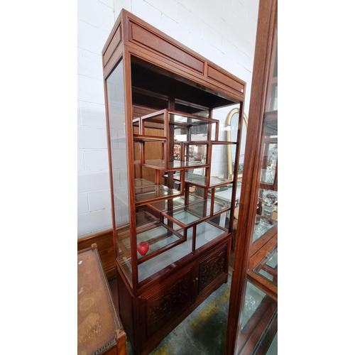 909 - A stunning Chinese rosewood display cabinet with glass shelves and mirrored back. A wonderful array ... 