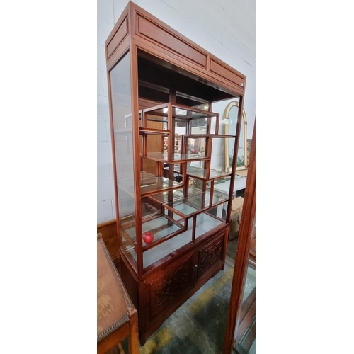 913 - A stunning Chinese rosewood display cabinet with glass shelves and mirrored back. A wonderful array ... 