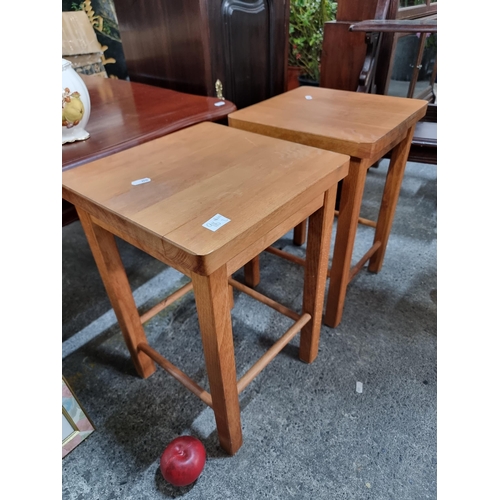 916 - A pair of wooden stools with square seats and four legs connected by stretchers. H46cm