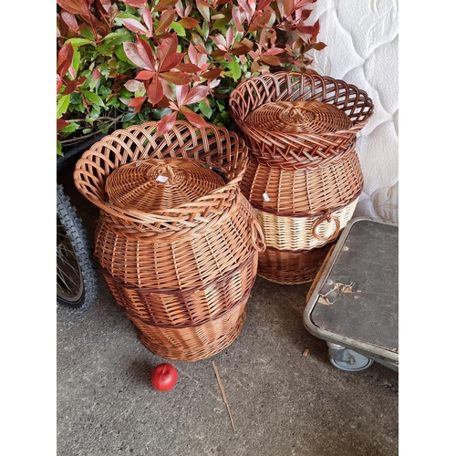 933 - A pair of large lidded wicker laundry baskets in the form of urns with fabric lining to interior and... 