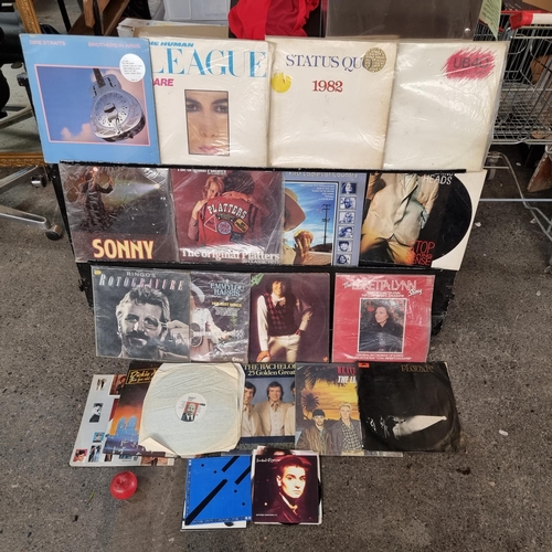 951 - A bag containing 26 vinyl records including examples such as The Human League's 