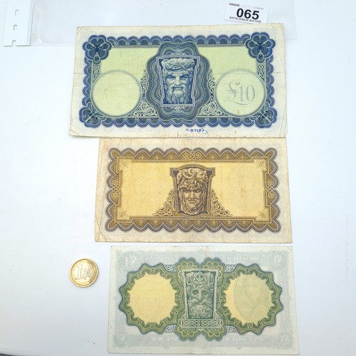 65 - Three Lady Lavery banknotes including a £1 banknote dating to 21.4.1975, along with a £5 note dating... 