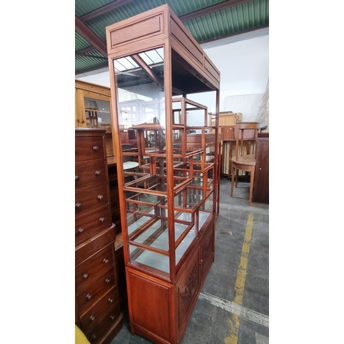 913 - A stunning Chinese rosewood display cabinet with glass shelves and mirrored back. A wonderful array ... 