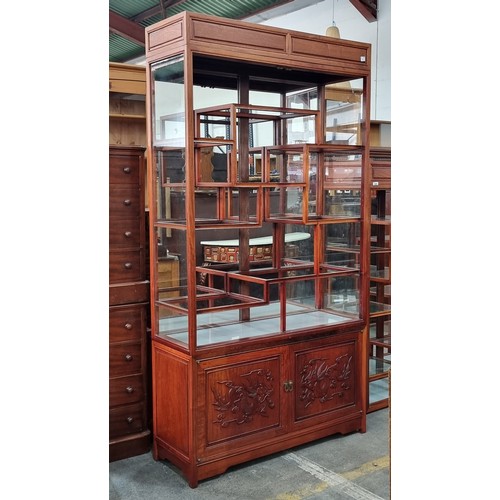 913 - A stunning Chinese rosewood display cabinet with glass shelves and mirrored back. A wonderful array ... 