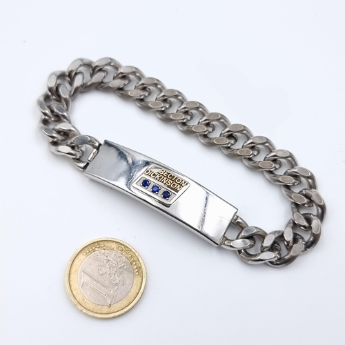 15 - A heavy gauge chain link gentleman's identity bracelet, set in stainless steel and featuring three s... 