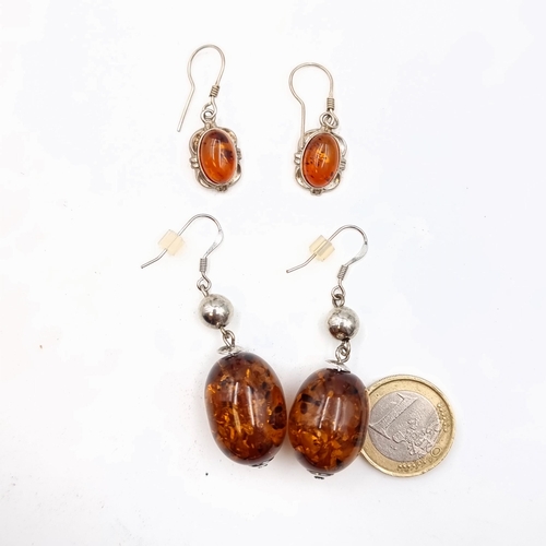 3 - Two stunning pairs of sterling silver drop earrings, both featuring natural Baltic Amber accents.