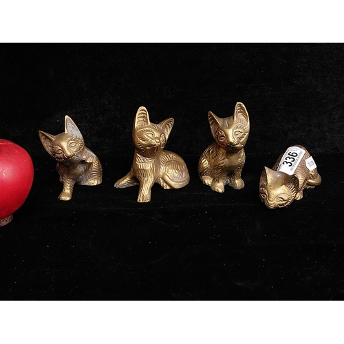 336 - A set of four adorable brass cat figures in various playful positions.