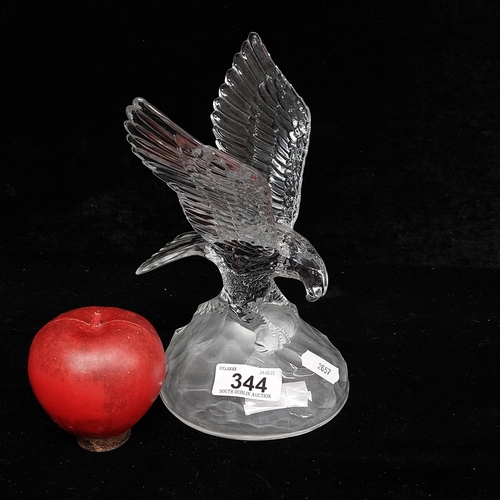 344 - A glass figure depicting a proud eagle perched on a rock while holding its prey. In very good condit... 