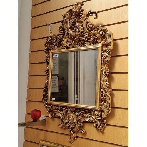 361 - A fabulous and striking antique gilt wall mirror designed in a Rococo composite style displaying lav... 