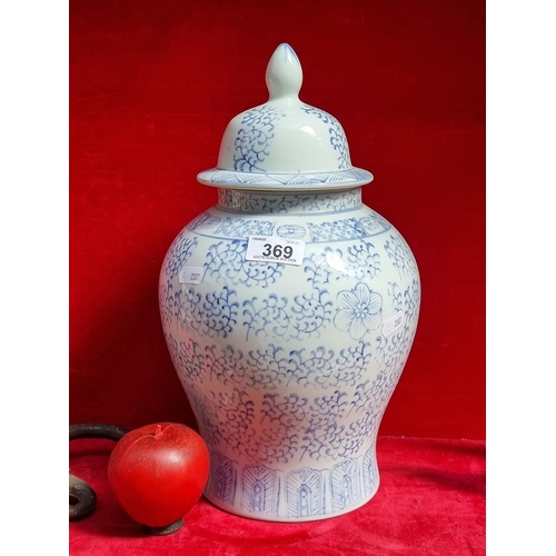 369 - A large  Chinese ceramic ginger jar in a blue and white pattern.