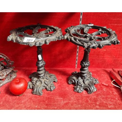 383 - A pair of cast metal plant stands with pierced detailing and foliate accents. H28cm