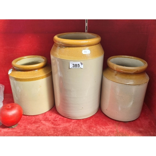 385 - Three earthenware jars in various sizes with a two-toned glaze. H28cm, 20cm and 19cm.