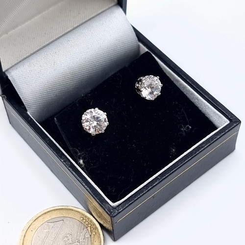 41 - An attractive pair of 9 carat White Gold White Sapphire stud earrings. Set with butterfly backs.