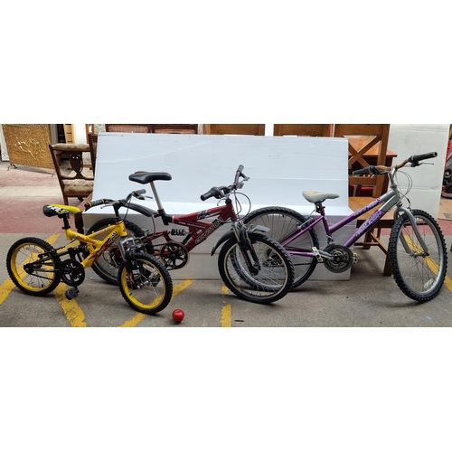 428 - Three colorful children's bicycles comprising of a bright yellow Raleigh 