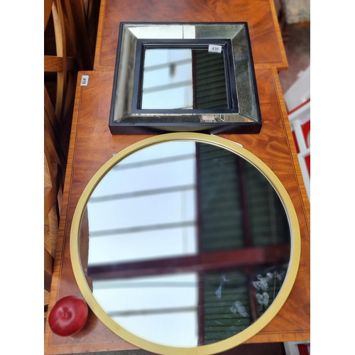 430 - Two stylish contemporary wall mirrors comprising of a square compartment mirror with glass paned fra... 