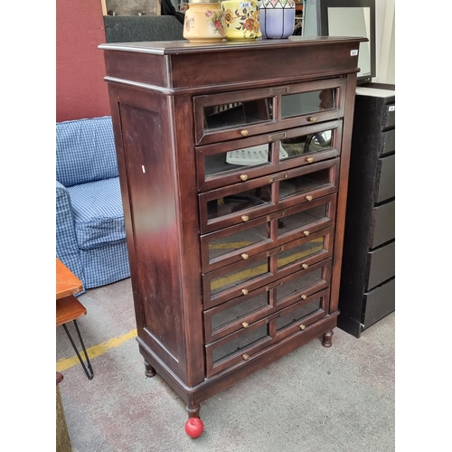 437 - Star lot : A fantastic Tall Boy storage unit. Featuring seven glazed drawers with single subdivision... 